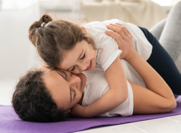 Medium shot woman holding girl