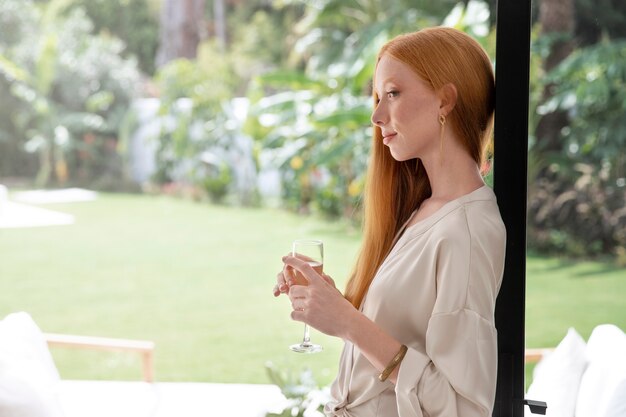 Medium shot woman holding glass