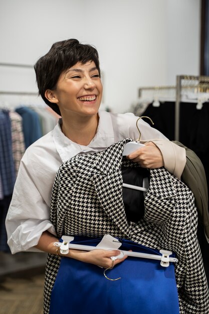 Medium shot woman holding hanger