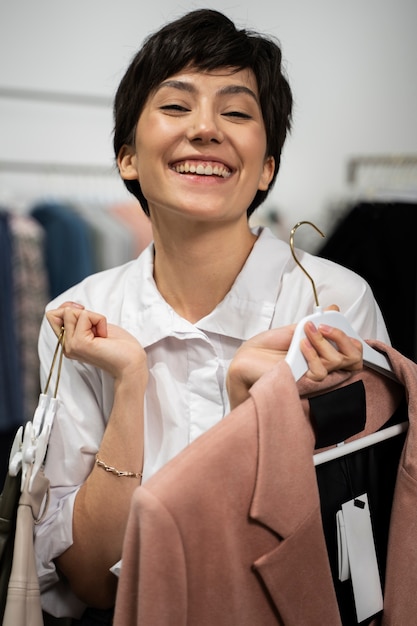 medium shot woman holding hangers