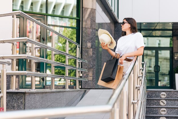 Medium shot woman holding her hat