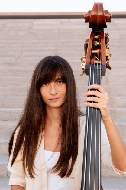 Medium shot woman holding instrument