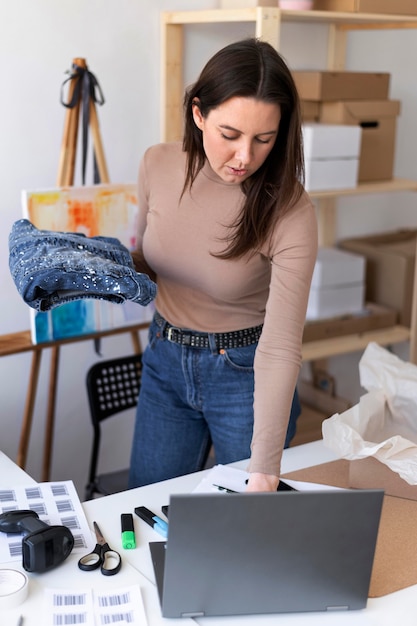 Medium shot woman holding item