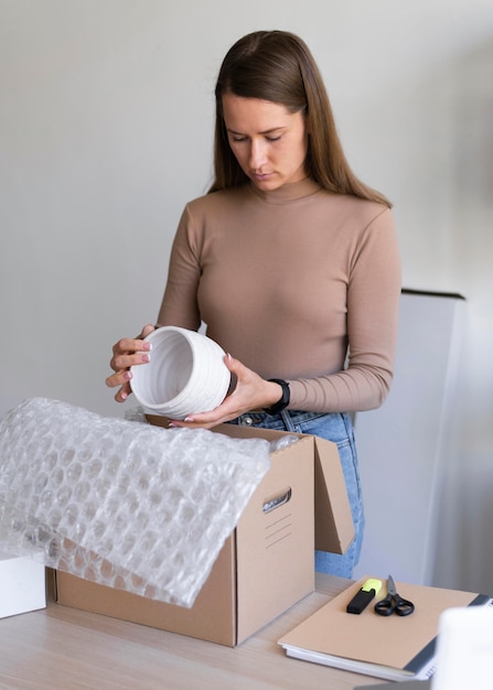 Medium shot woman holding item