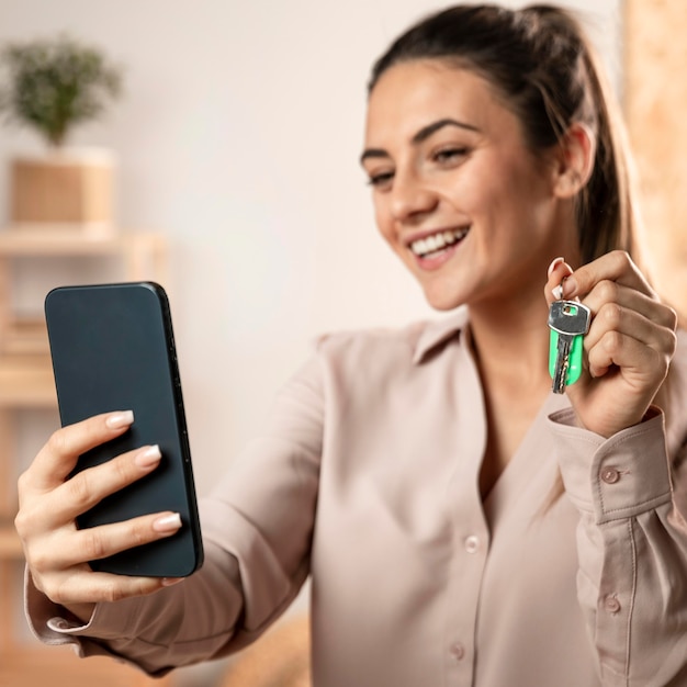 Medium shot woman holding keys