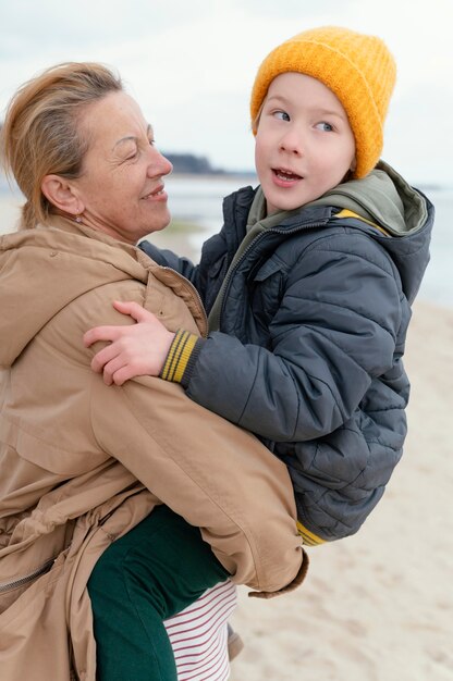 Medium shot woman holding kid