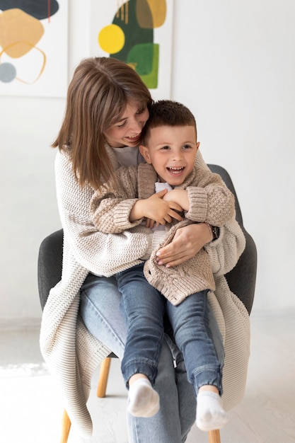 Medium shot woman holding kid