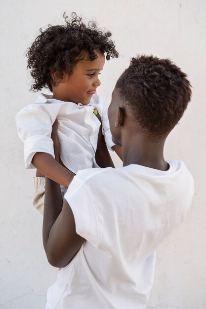 Medium shot woman holding kid