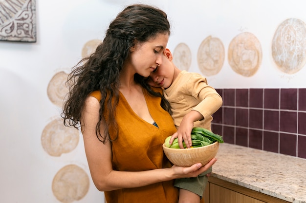 Medium shot woman holding kid