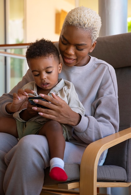 Medium shot woman holding kid