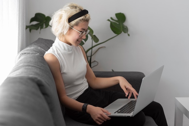 Medium shot woman holding laptop