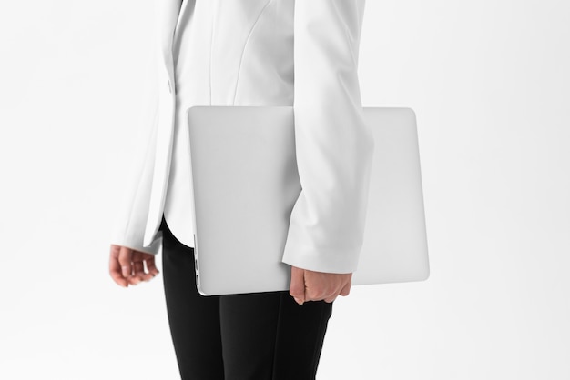 Medium shot woman holding laptop