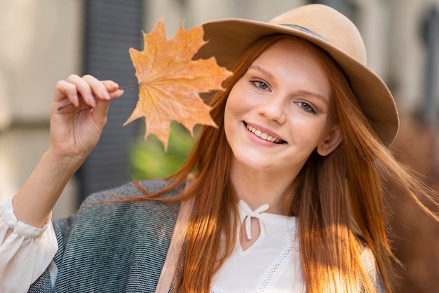 Medium shot woman holding leaf