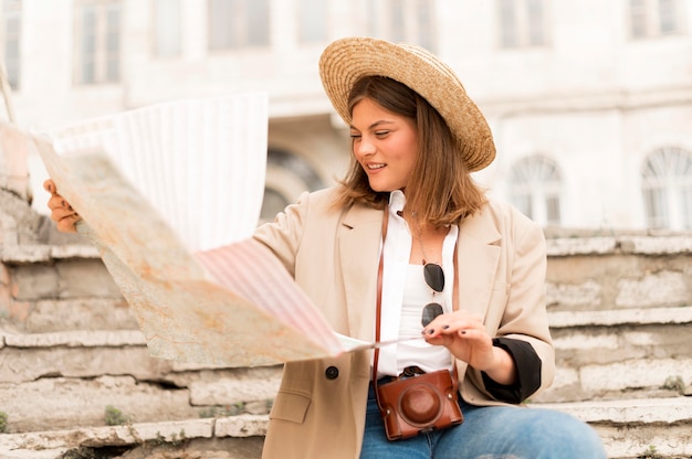 Free photo medium shot woman holding map