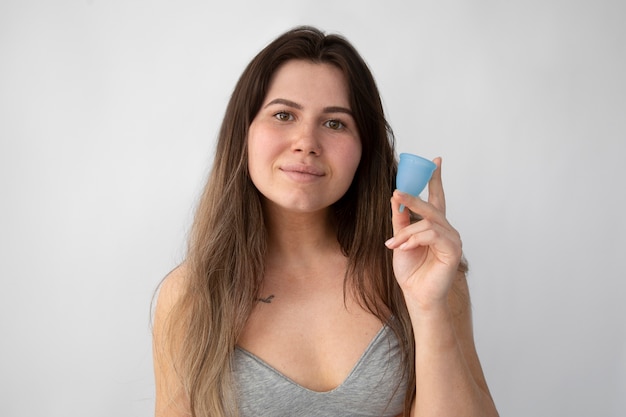 Medium shot woman holding menstrual cup