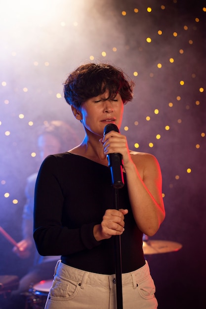 Medium shot woman holding microphone