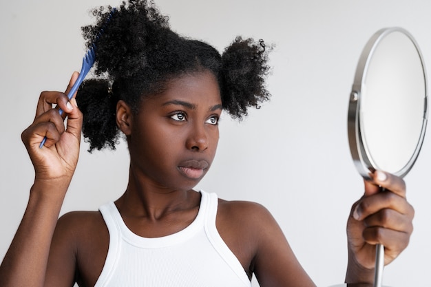 Free photo medium shot woman holding mirror