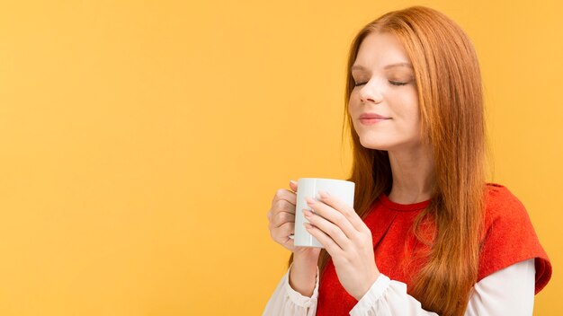 Medium shot woman holding mug