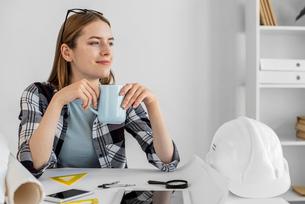 Medium shot woman holding mug