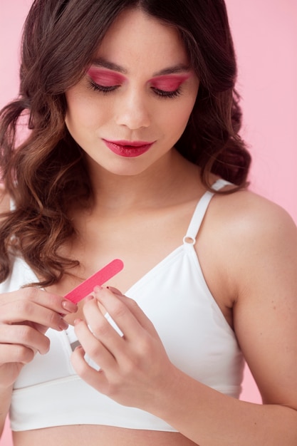 Medium shot woman holding nail file