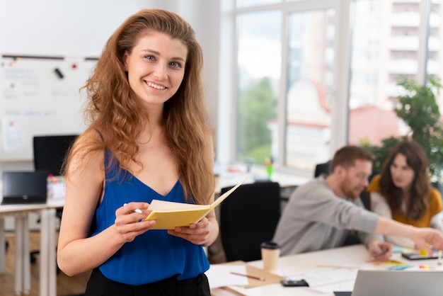 Medium shot woman holding notebook