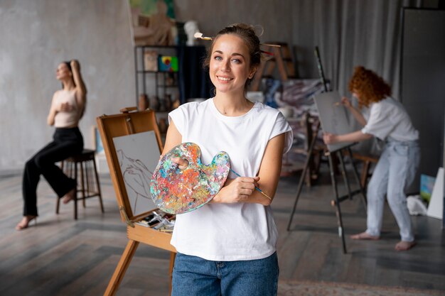 Medium shot woman holding palette