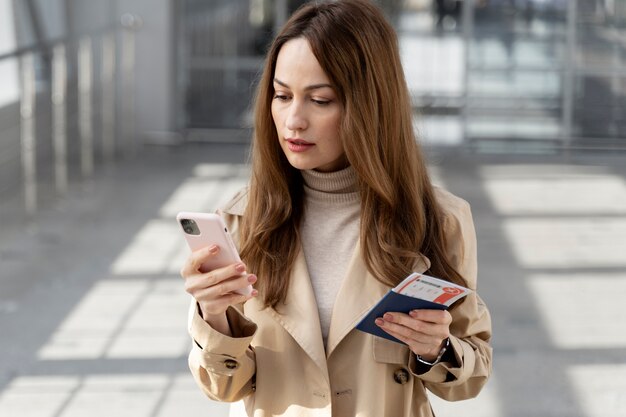 Medium shot woman holding passport