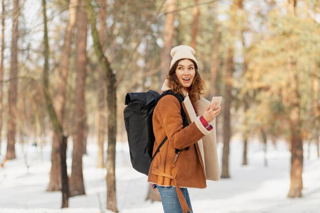 Medium shot woman holding phone