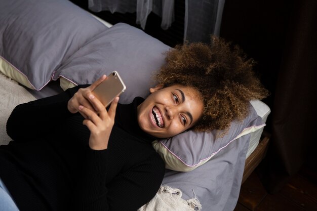 Medium shot woman holding phone