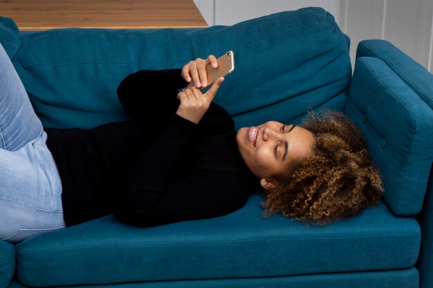 Medium shot woman holding phone