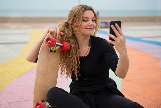 Medium shot woman holding phone