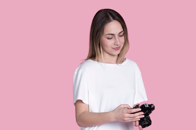 Medium shot woman holding photo camera