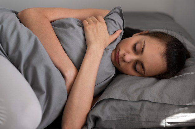 Medium shot woman holding pillow