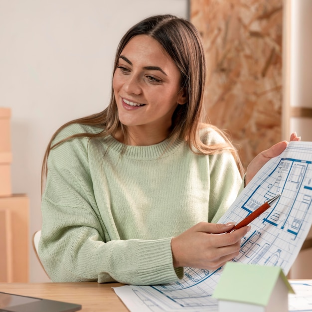 medium shot woman holding plan