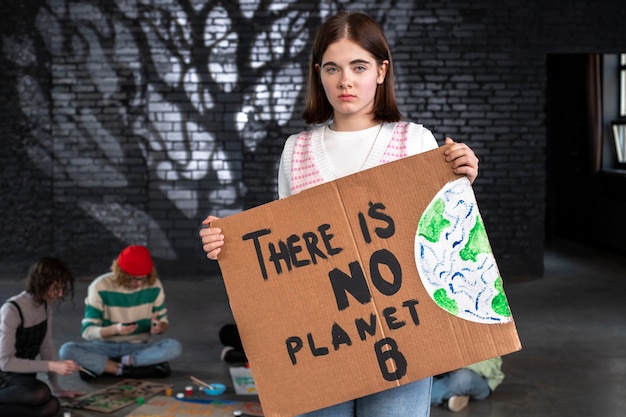 Medium shot woman holding protest banner