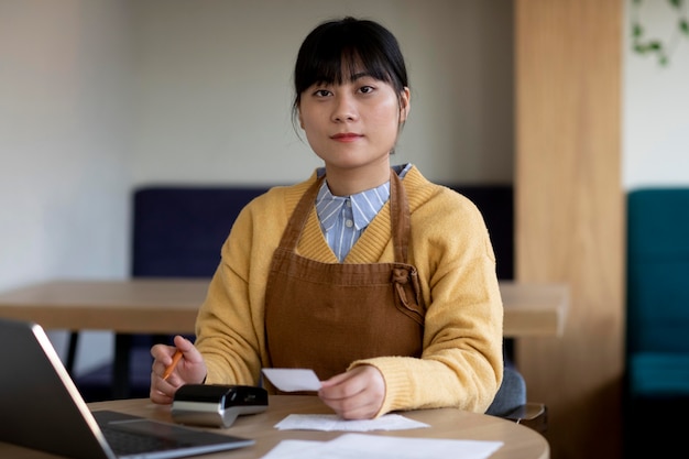 Medium shot woman holding receipt