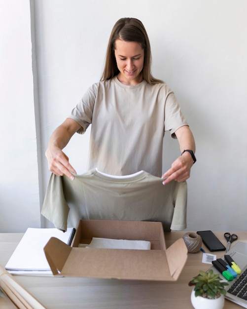Medium shot woman holding shirt