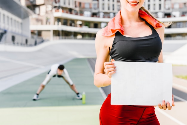 Medium shot of woman holding sign