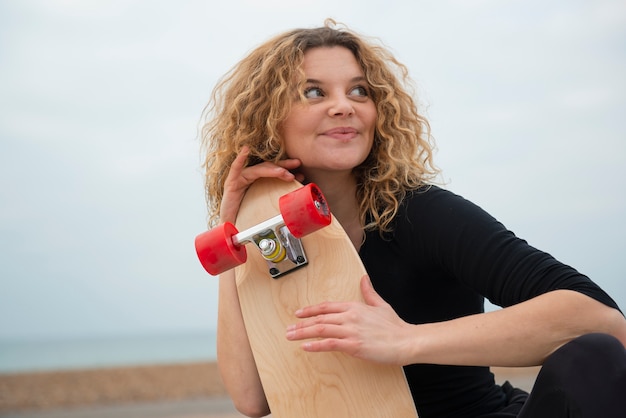 Medium shot woman holding skate