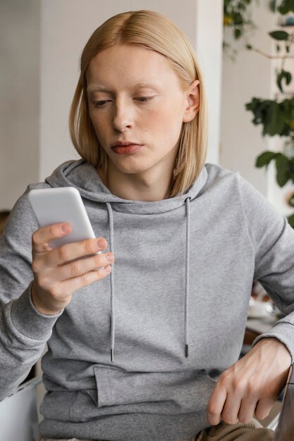 medium shot woman holding smartphone