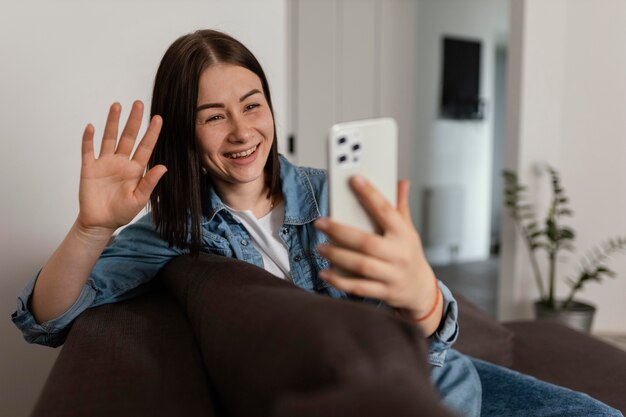 Medium shot woman holding smartphone