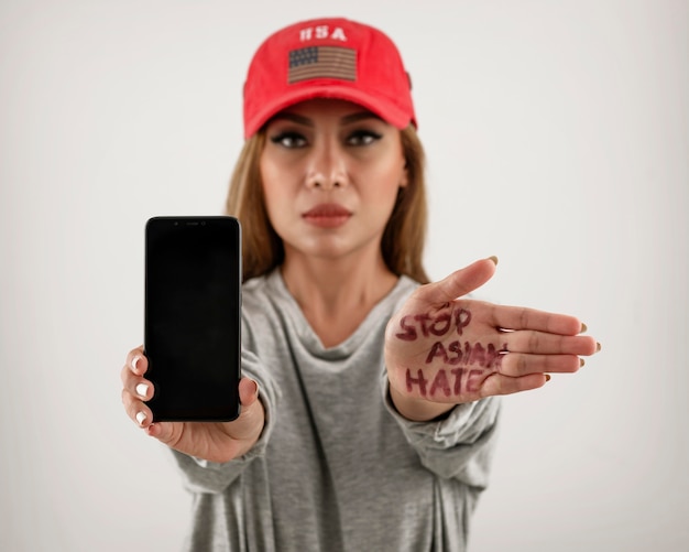 Medium shot woman holding smartphone