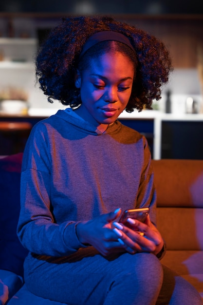 Medium shot woman holding smartphone