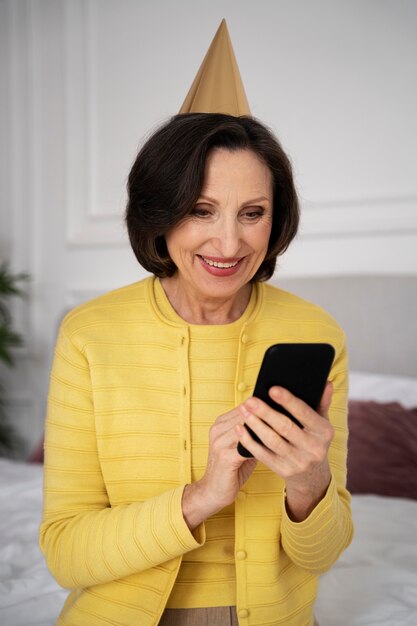 Medium shot woman holding smartphone