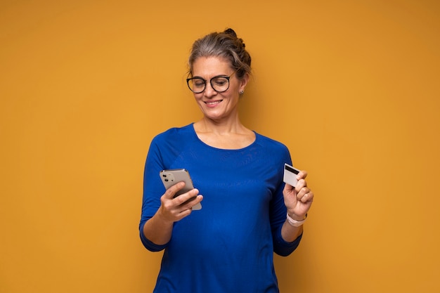 Medium shot woman holding smartphone