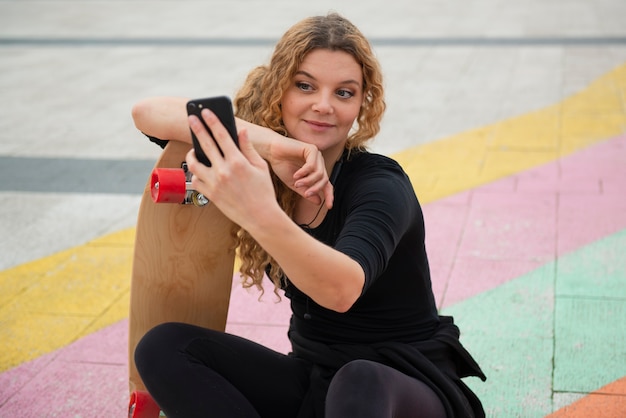 Medium shot woman holding smartphone