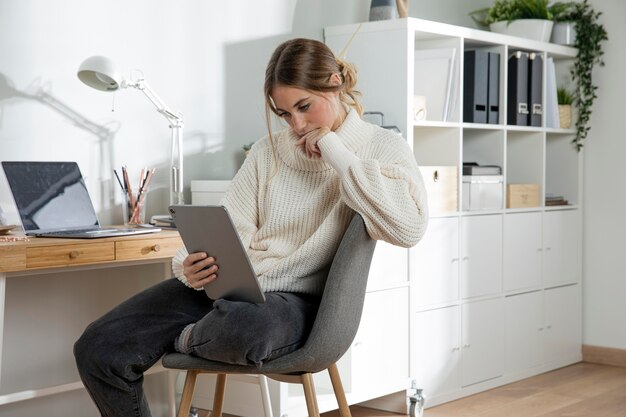 Medium shot woman holding tablet