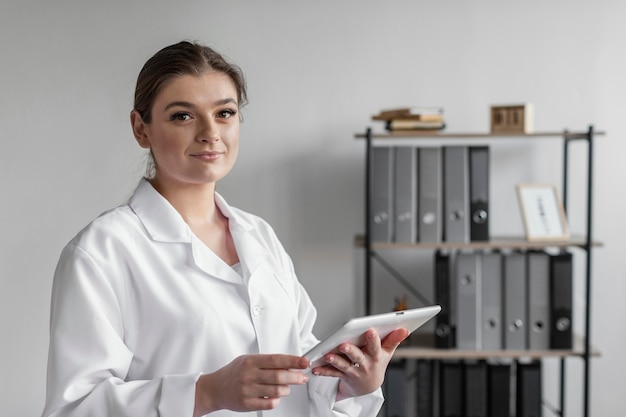 Medium shot woman holding tablet