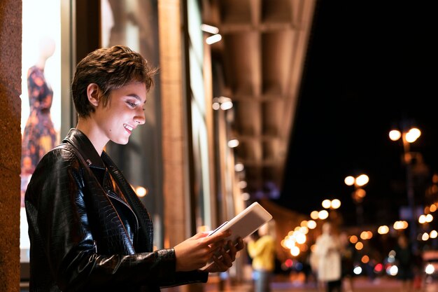 Medium shot woman holding tablet