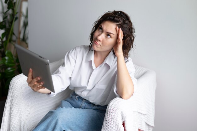 Medium shot woman holding tablet